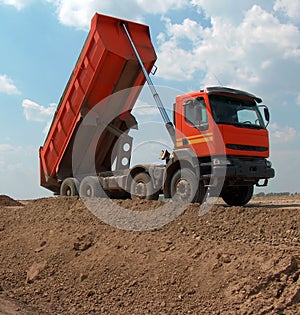 Orange truck dumper