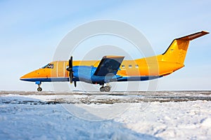 Orange turboprop aircraft