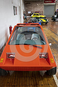 An orange 1977 Urba Car at Lane Motor Museum with the largest collection of vintage European cars, motorcycles and bicycles