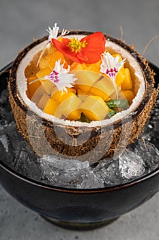 Orange vegetables and fruit with chia seeds and mango, ingredients on dark concrete background