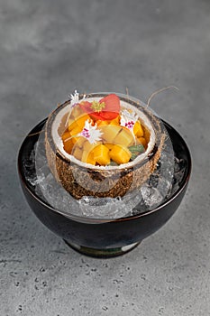 Orange vegetables and fruit with chia seeds and mango, ingredients on dark concrete background