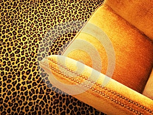 Orange velvet armchair on leopard carpet