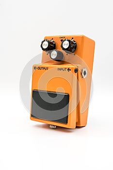 Orange vintage guitar pedal on white