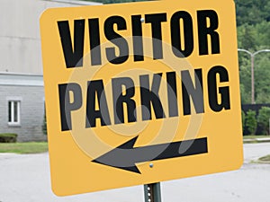 Orange visitor parking sign