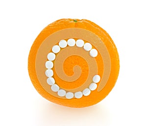 Orange with vitamin c pills over white background