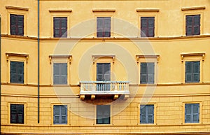 Orange wall with windows and balcony