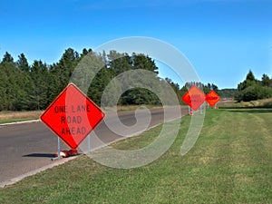 Orange Warning Road Signs on highway at construction site