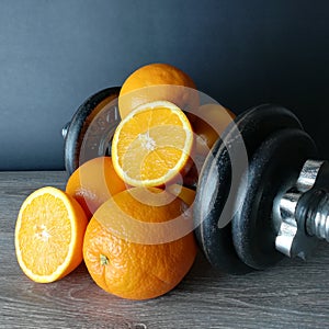 Orange with weights, health and fitness