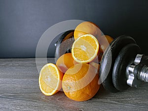 Orange with weights, health and fitness