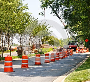 Orange and White Barrels in Road Construction