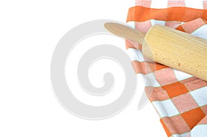 Orange white checkered dishcloth and rolling pin isolated on white