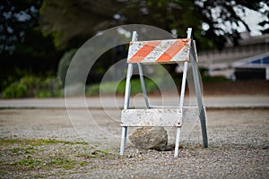 Orange and white diagonal striped construction barricade