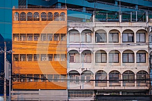 Orange and white facades of buildings in Bangkok, Thailand