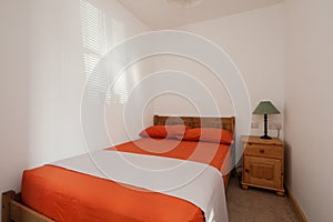 Orange and white furnished bedroom