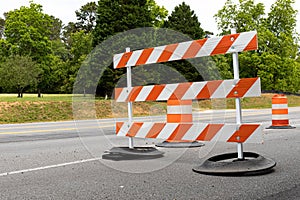 Orange and white striped road barricade, detour for street construction