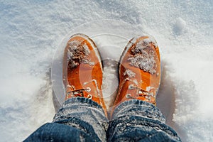 Orange winter shoes in snow