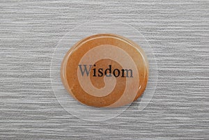 Orange Wisdom mood stone on gray background