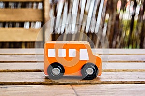 Orange wooden toy bus