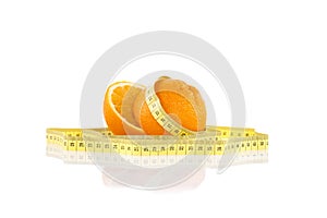Orange wrapped with a plastic yellow tape measure. Healthy, organic food and diet conc