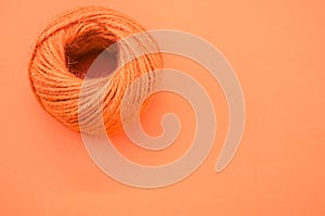 Orange yarn ball for knitting isolated on orange background