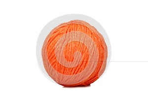 Orange yarn ball over white
