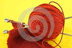 Orange yarn and knitting needles