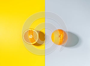 orange on yellow background. Citrus fruit on colored backdrop. Top view