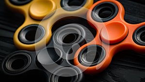 Orange, yellow and black spinners on a black background