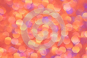 Orange, yellow, gold and purple abstract background. Bright sparkle and glow for festive backdrop.