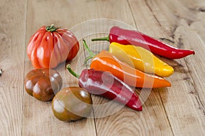 orange, yellow and red bell pepper and costoluto genovese tomato