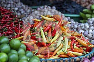 Orange, yellow and red sweet peppers for sale at street food market in the old town of Hanoi, Vietnam