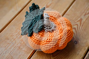 Orange-yellow wicker pumpkin on a tree background. Preparing for the Halloween concept. Top view. Handmade creative