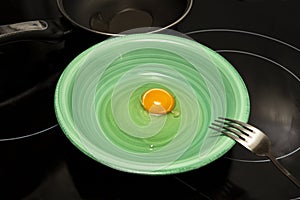 orange yolk and egg white on a green plate