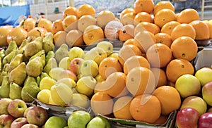 Oranges, apples, pears lie on the market counter for sale