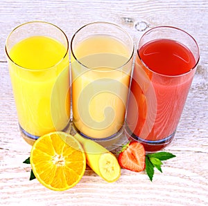 Oranges, bananas, strawberry slice, juice in glass