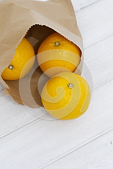 Oranges in a brown paper bag.  Environmentally friendly packaging concept