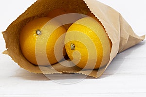 Oranges in a brown paper bag.  Environmentally friendly packaging concept