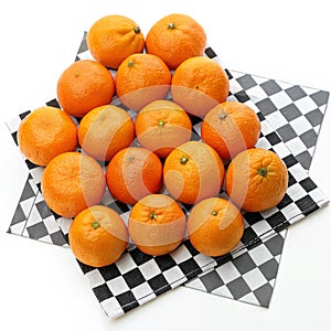 Oranges on a checkered background on white background