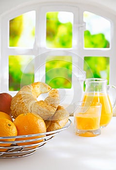Oranges and croissants for a summer breakfast