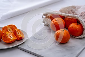 Oranges on cutting board with white background