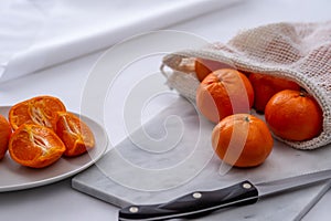 Oranges on cutting board with white background