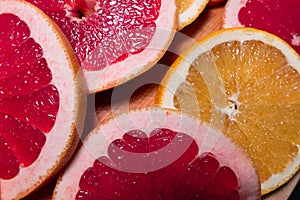 Oranges fruit on black wooden boards. Halves of juicy orange on black background. Orange fruit, citrus minimal concept. Top view,