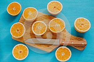 Oranges, orange juice and slices of fruit in blue background photo