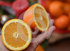 oranges in hand and a bag of tangerines