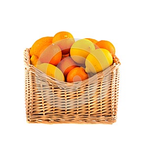 Oranges and lemons in a wooden basket, isolated on white background. Fruit.