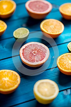 Oranges limet lemon and grapefruit on blue table.