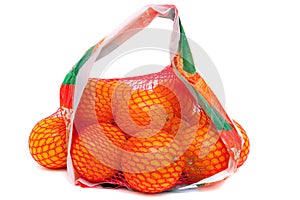 Oranges in a plastic bag on white background