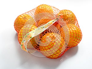 Oranges in Plastic Mesh Sack on White Background
