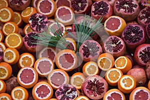 Oranges and pomegranates are sliced for juice