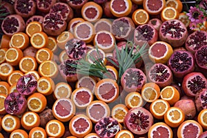 Oranges and pomegranates are sliced for juice